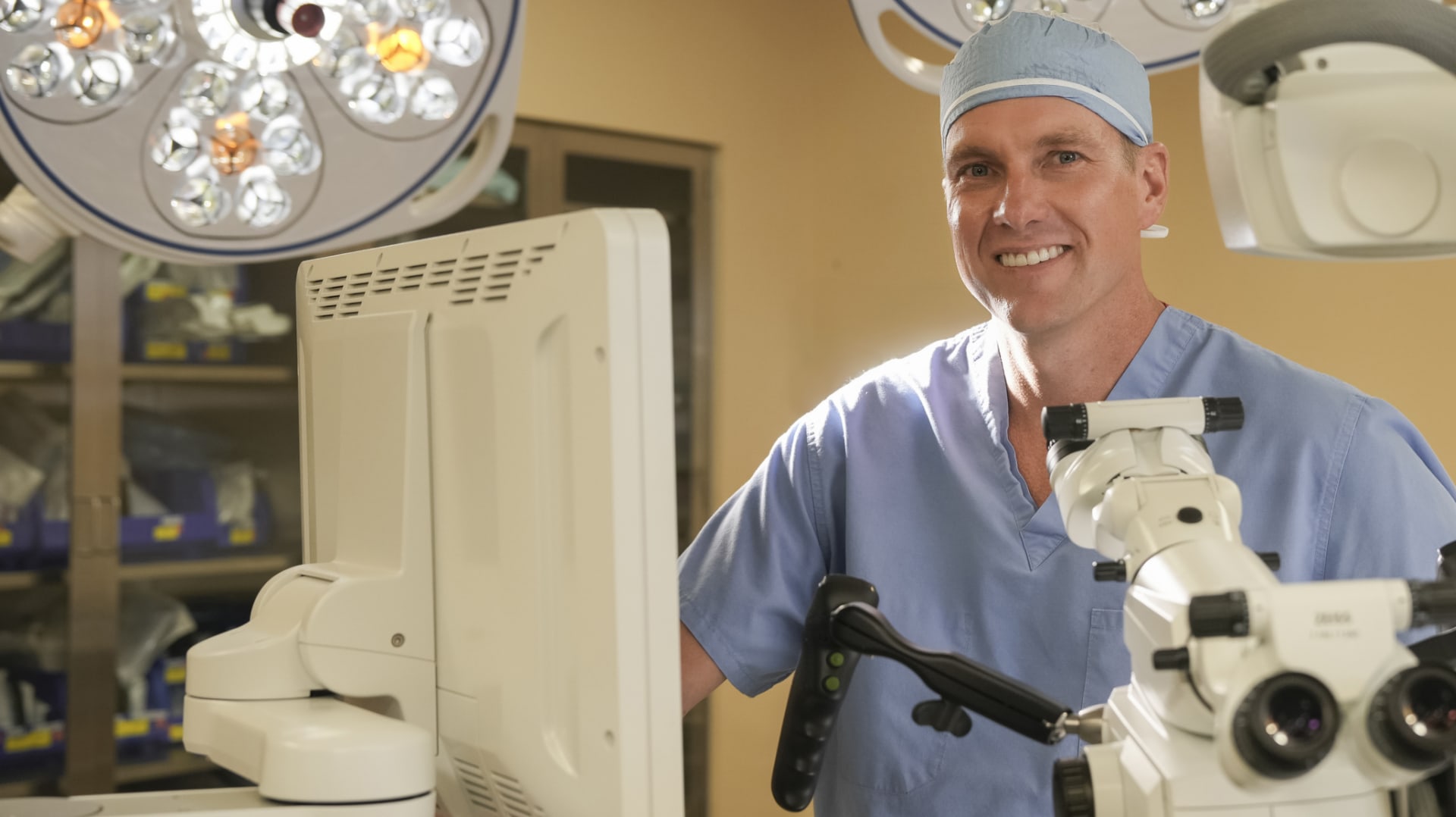 Dr. Kevin O'Neill smiling in surgical scrubs